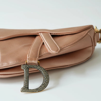 Detail view of crystal-embellished D stirrup charm and CD hardware
