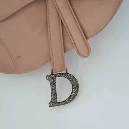 Detail view of crystal-embellished D stirrup charm and CD hardware