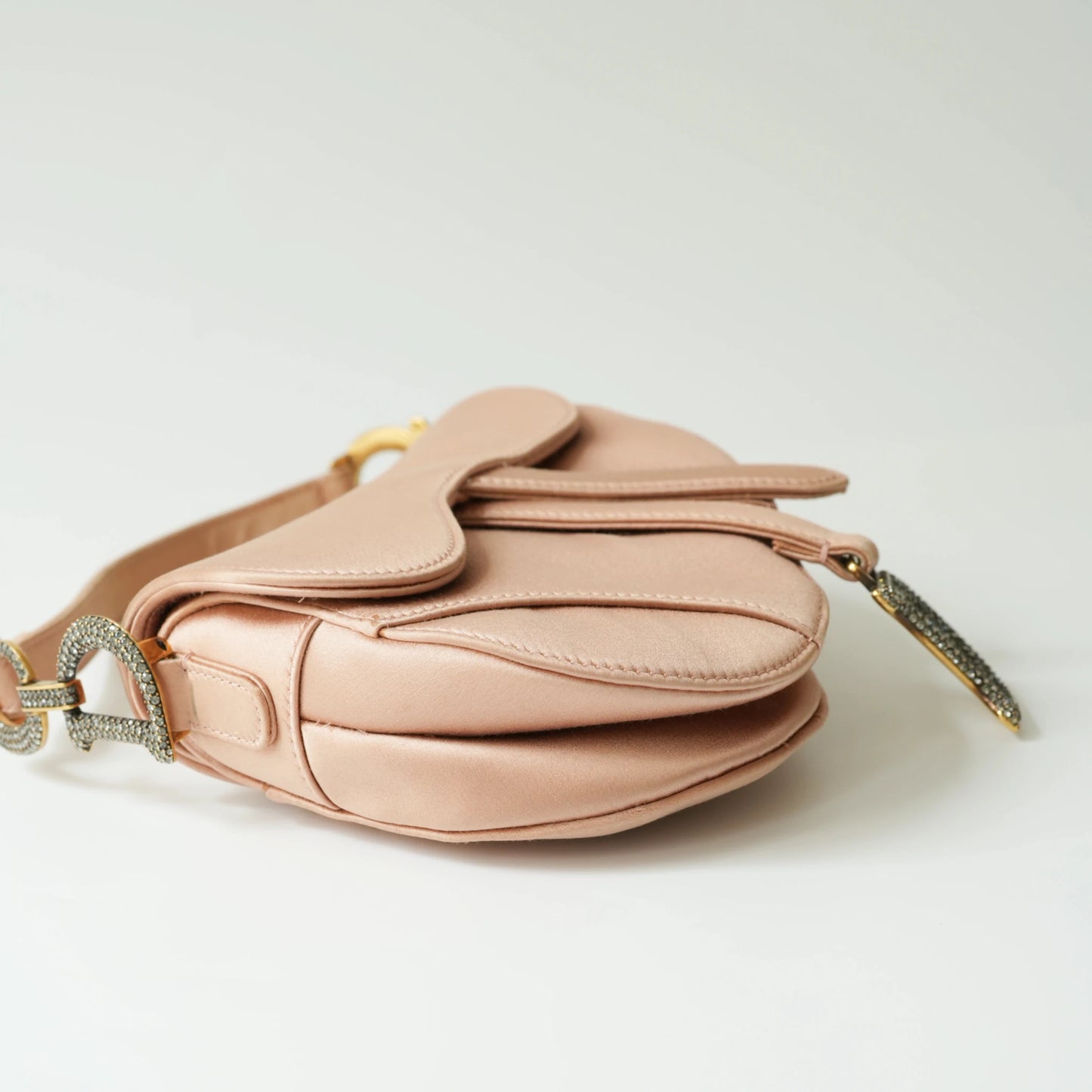 Detail view of crystal-embellished D stirrup charm and CD hardware