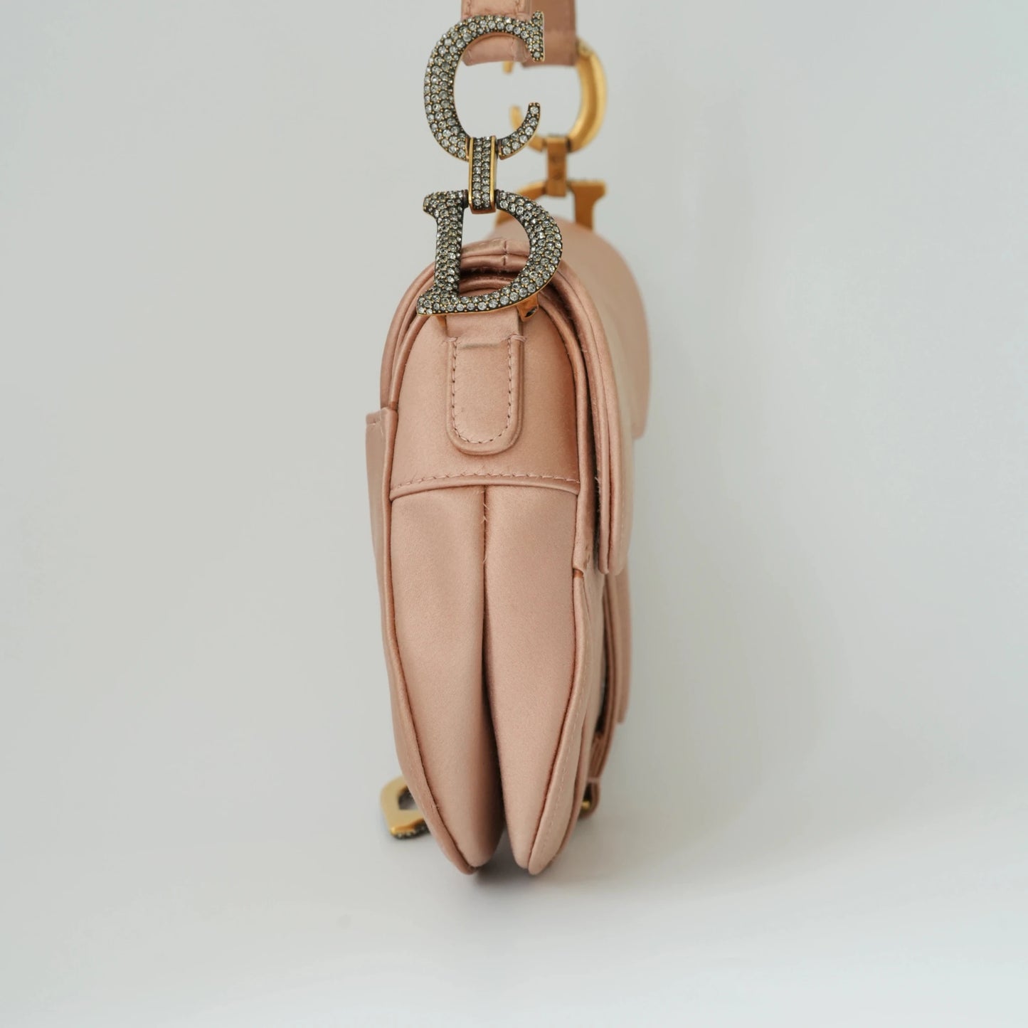 Detail view of crystal-embellished D stirrup charm and CD hardware