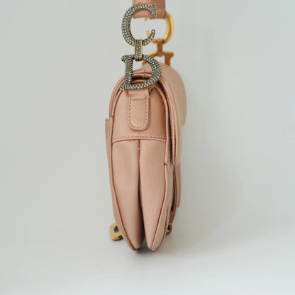 Detail view of crystal-embellished D stirrup charm and CD hardware