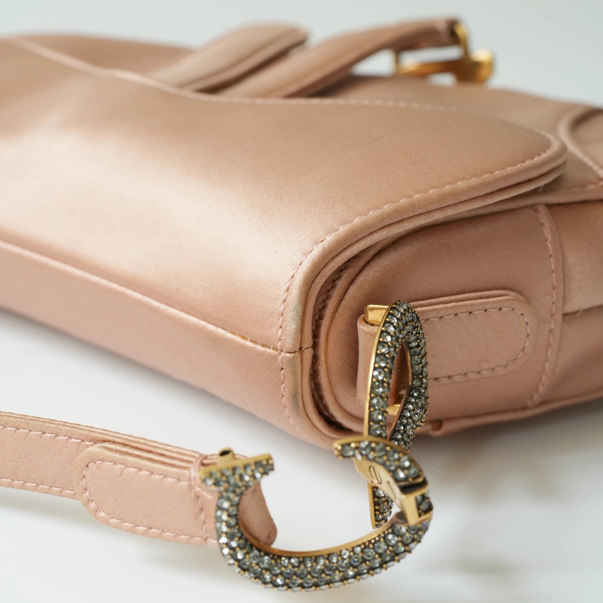 Detail view of crystal-embellished D stirrup charm and CD hardware