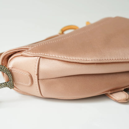 Detail view of crystal-embellished D stirrup charm and CD hardware