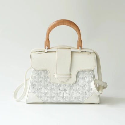Front view of Goyard Mini Saigon Souple bag in white with wooden top handle