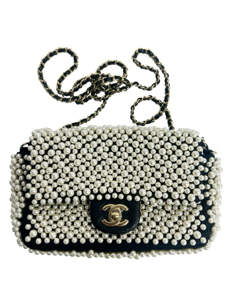 Chanel 19S black lambskin mini classic flap bag fully adorned with hand-set white pearls, light gold CC turnlock and leather woven chain strap front view