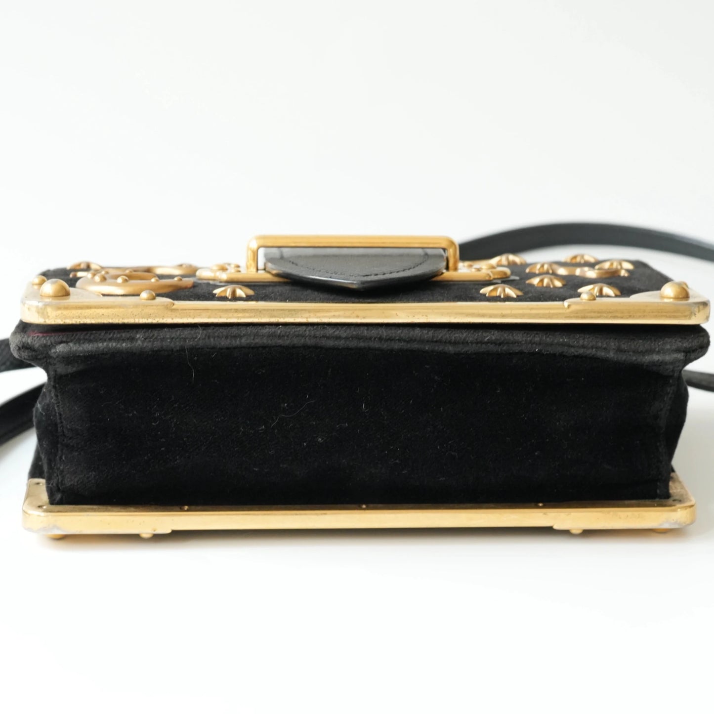 Bottom view of Prada Cahier bag with gold metal corner guards
