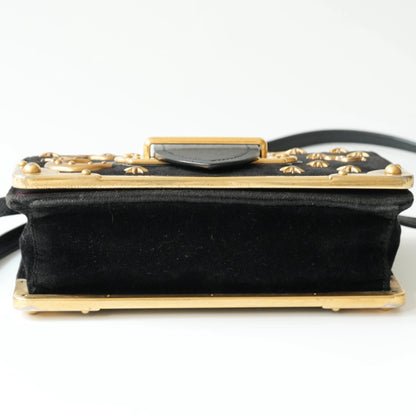 Bottom view of Prada Cahier bag with gold metal corner guards