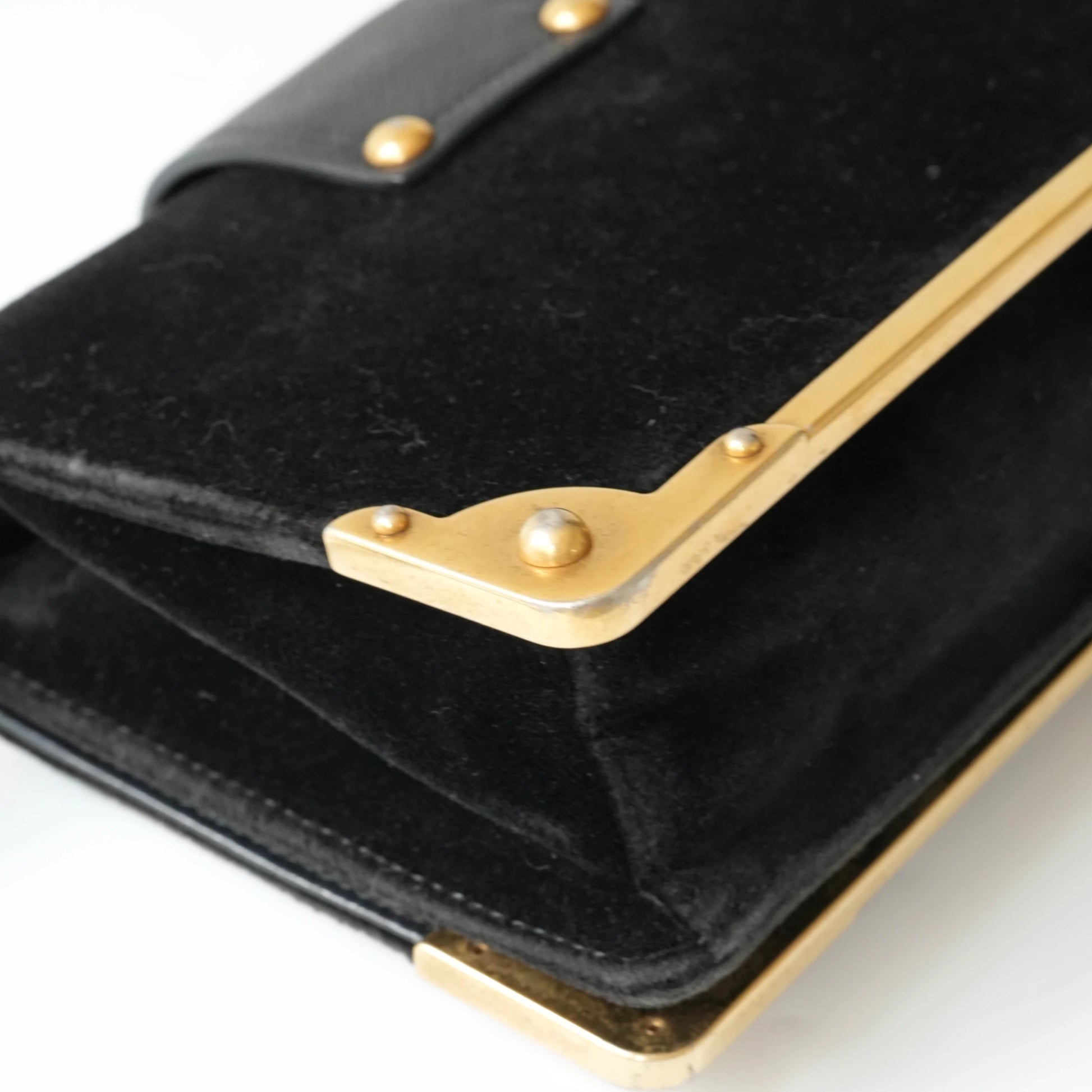 Detail view of gold Prada logo and celestial metal embellishments