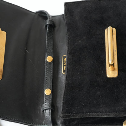 Detail view of gold Prada logo and celestial metal embellishments