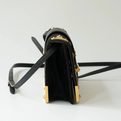 Side view of Prada Cahier bag showing structured box silhouette