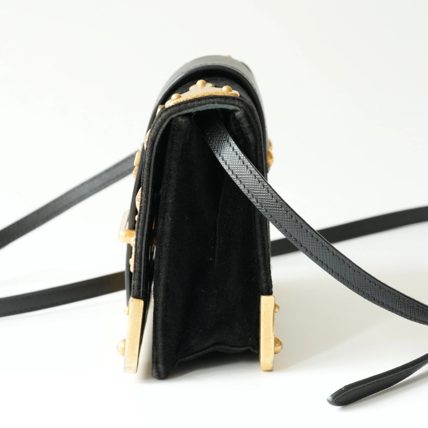 Side view of Prada Cahier bag showing structured box silhouette
